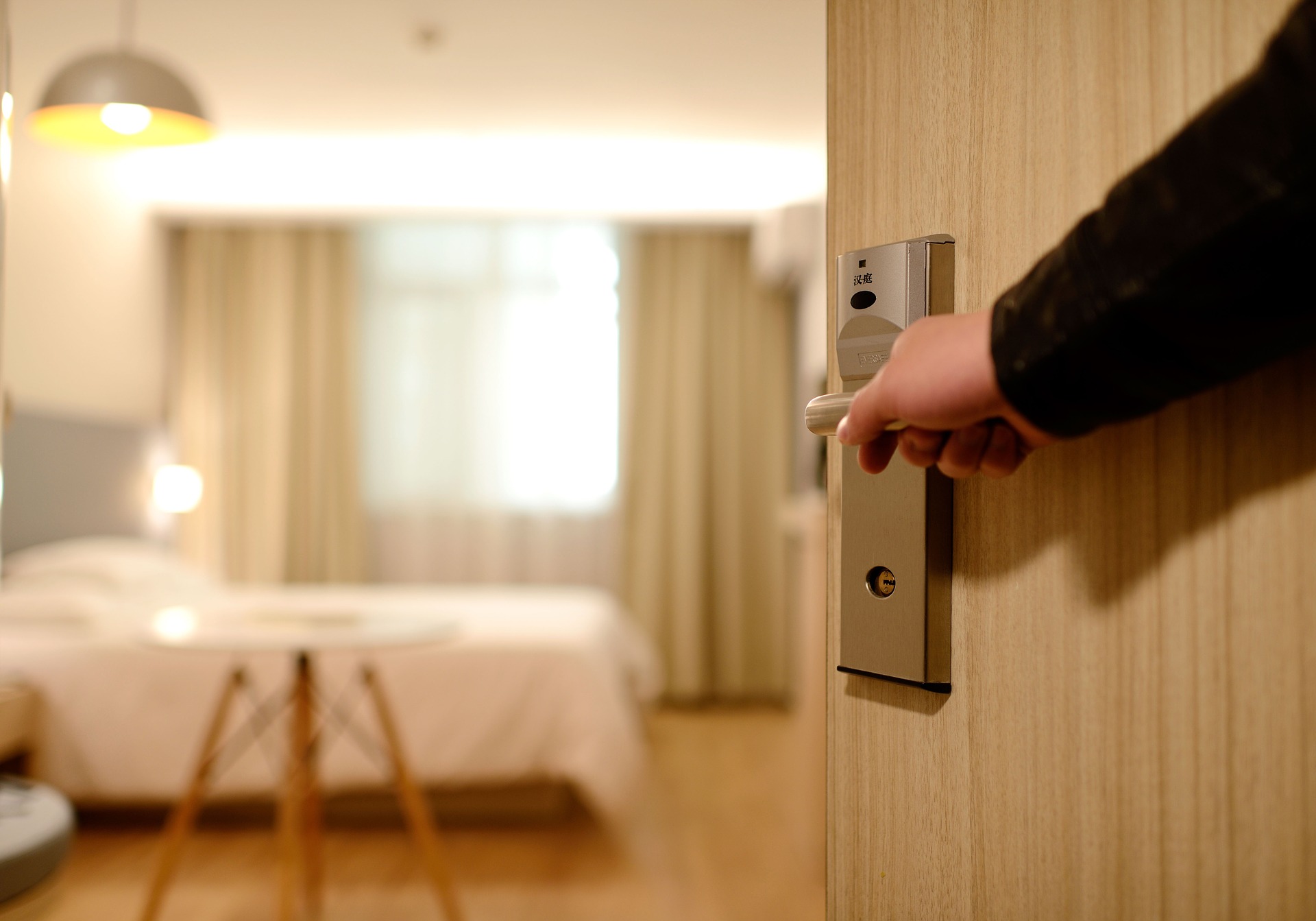 Guest opens the door of a hotel room