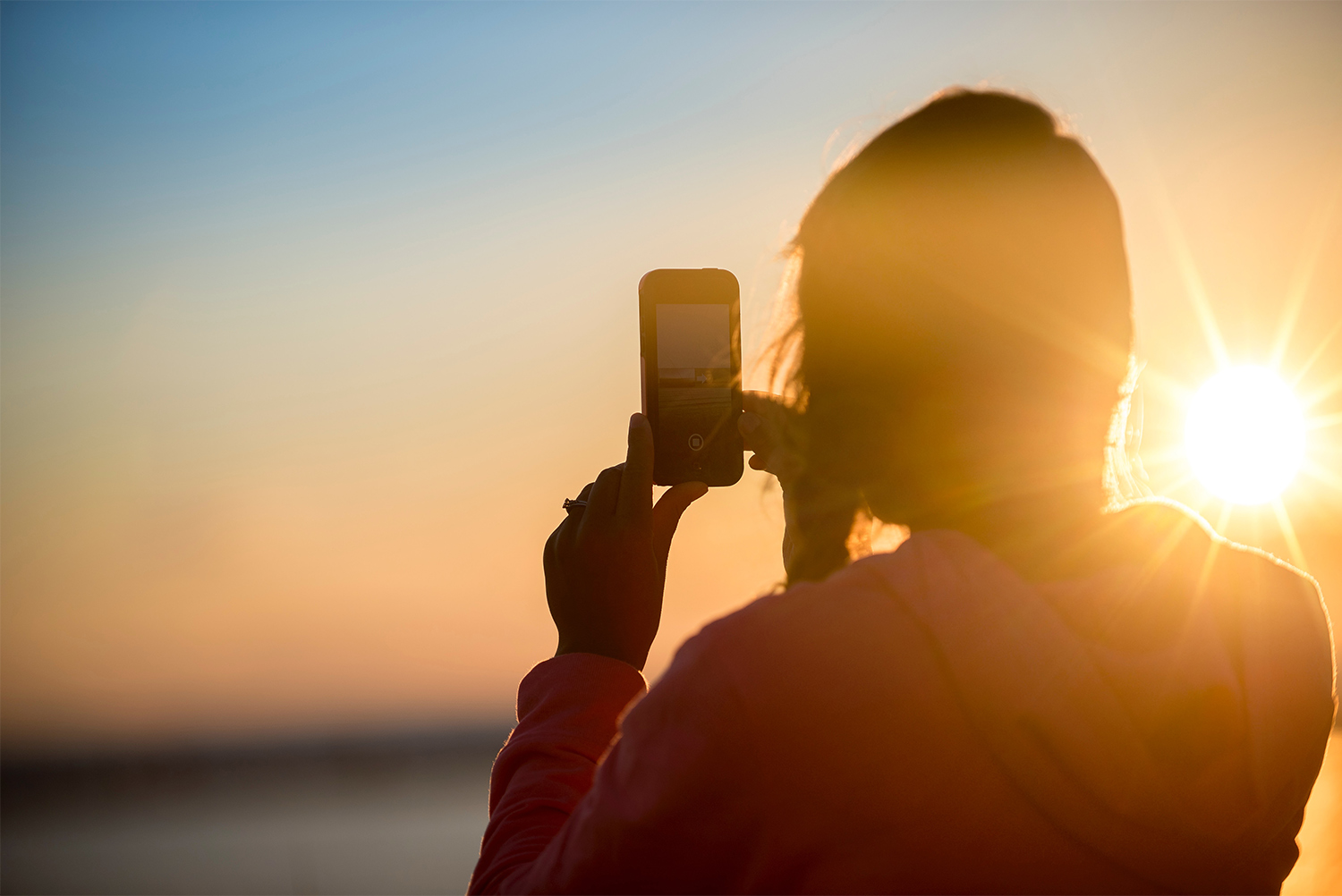 Traveler takes a photo at sunset