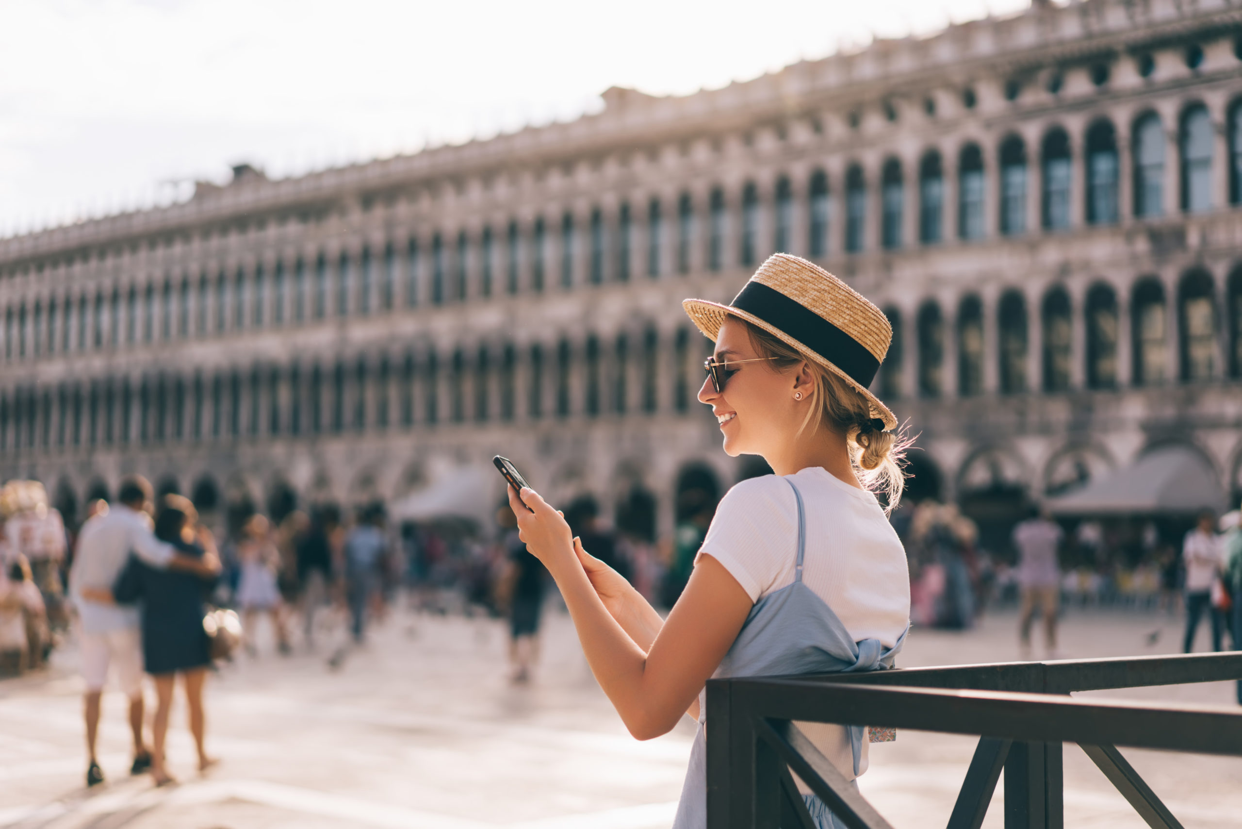 Happy Caucasian woman checking information on smartphone device