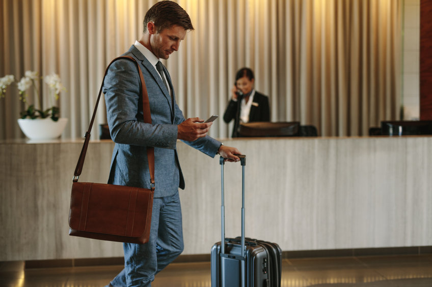 Businessman consults an app in a hotel lobby