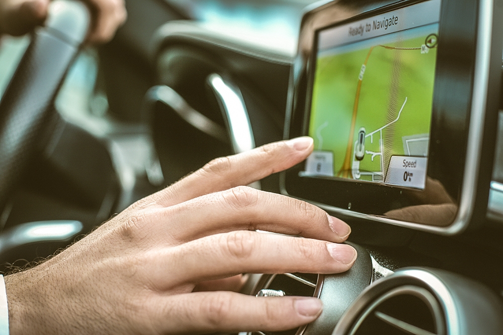 Detail of a driver's finger setting his car's navigator